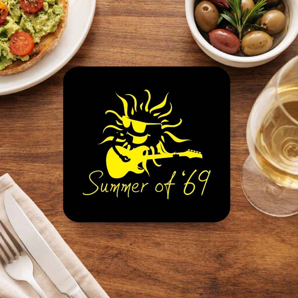 Coaster with yellow graphic and 'Summer of '69' text on a wooden table with food and drink. Bryan Adams The Banyan Tee gift