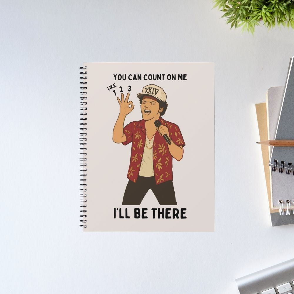 Notebook with an illustration of a person and text on a white surface Bruno Mars Gift The Banyan Tee India