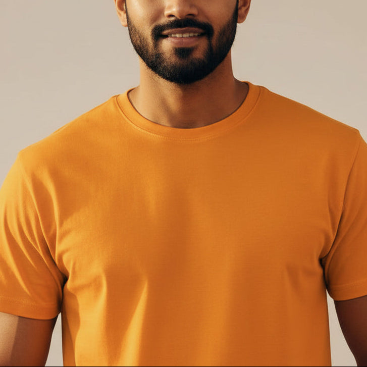 Man wearing an orange t-shirt against a beige background