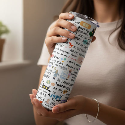 Person holding a tumbler with a colorful design and text.