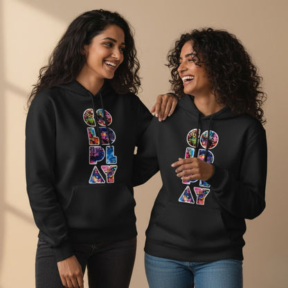 Two people wearing black hoodies with colorful text design on a beige background