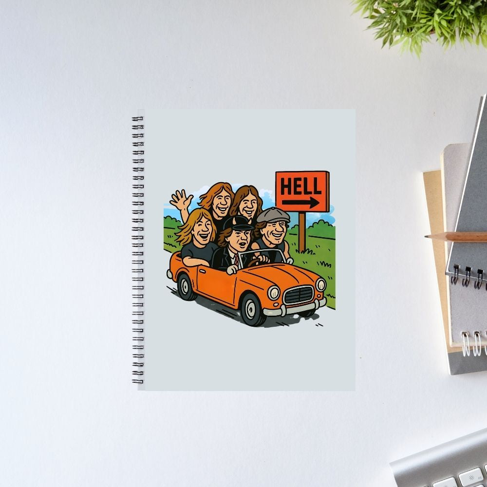 Notebook with a cartoon illustration of people in a car and a 'Hell' sign on a white surface. Notebook AC/DC The Banyan Tee