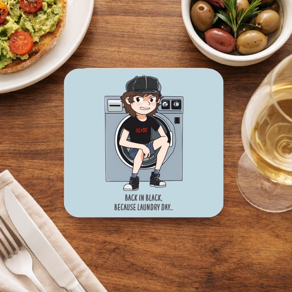 Coaster with a cartoon character sitting in a washing machine on a dining table with food and drink. AC/DC coaster The Banyan Tee
