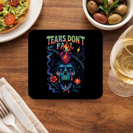 Coaster with colorful skull design and 'Tears Don't Fail' text on a wooden table with food and drink. Bullet for my valentine.