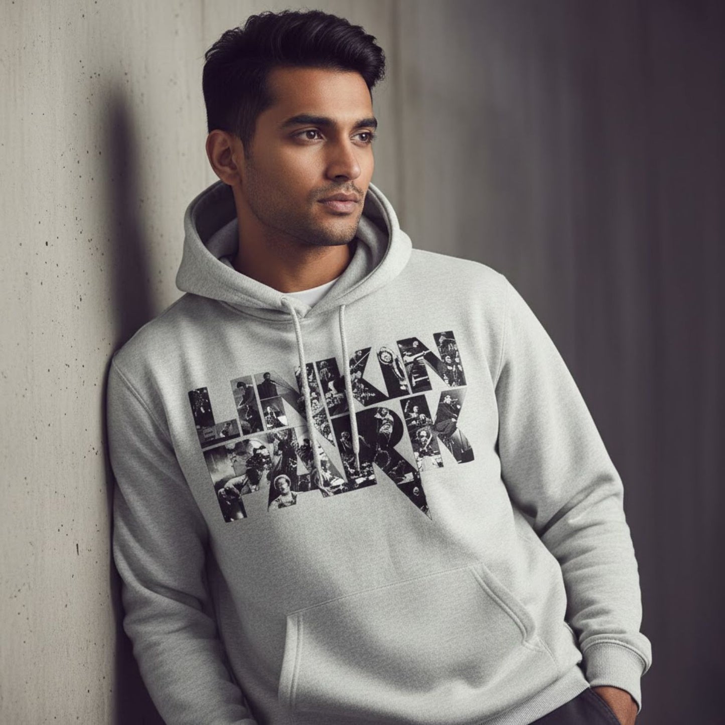 Man wearing a hoodie with 'Linkin Park' design leaning against a wall.