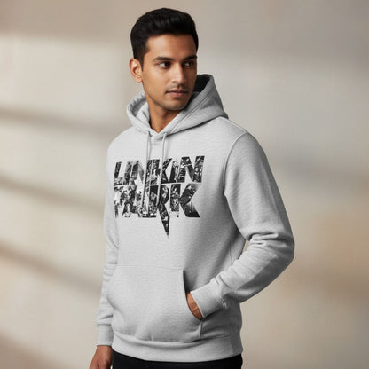 Man wearing a gray hoodie with text on a neutral background