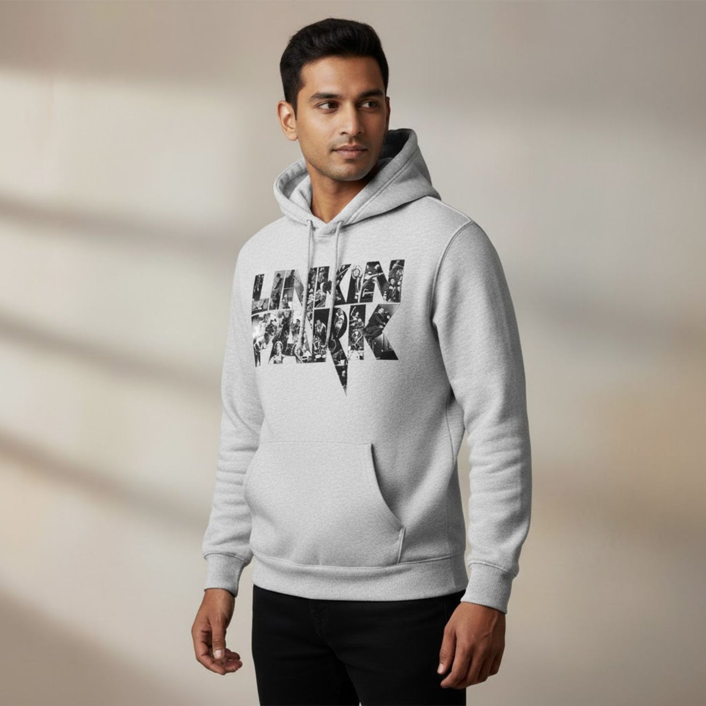 Man wearing a gray hoodie with 'Linkin Park' logo on a beige background