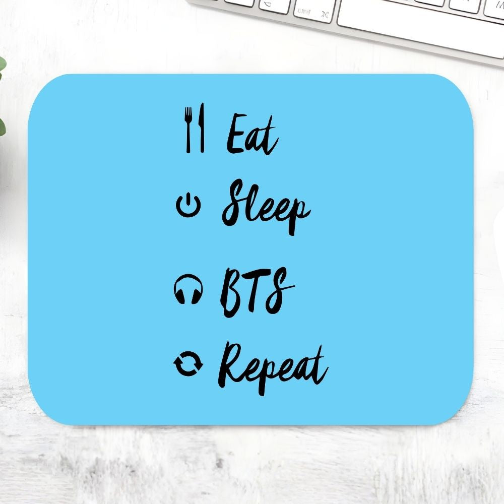 BTS Eat Sleep Repeat Mousepad – Sky blue large desk mat with Eat Sleep BTS Repeat calligraphy and music-themed icons fork headphones, K-pop fan stationery desk gift, The Banyan Tee India