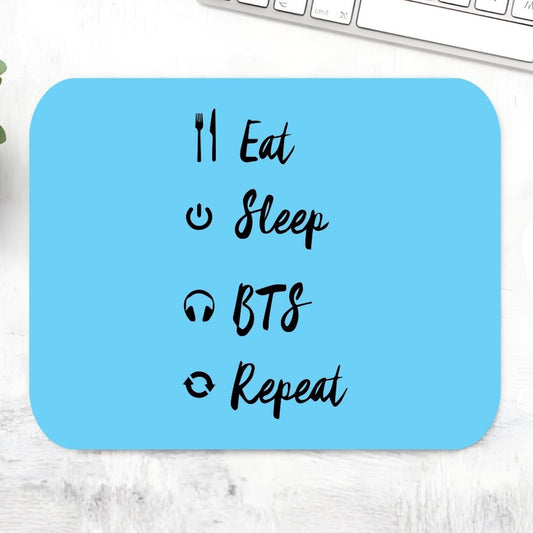 BTS Eat Sleep Repeat Mousepad – Sky blue large desk mat with Eat Sleep BTS Repeat calligraphy and music-themed icons fork headphones, K-pop fan stationery desk gift, The Banyan Tee India