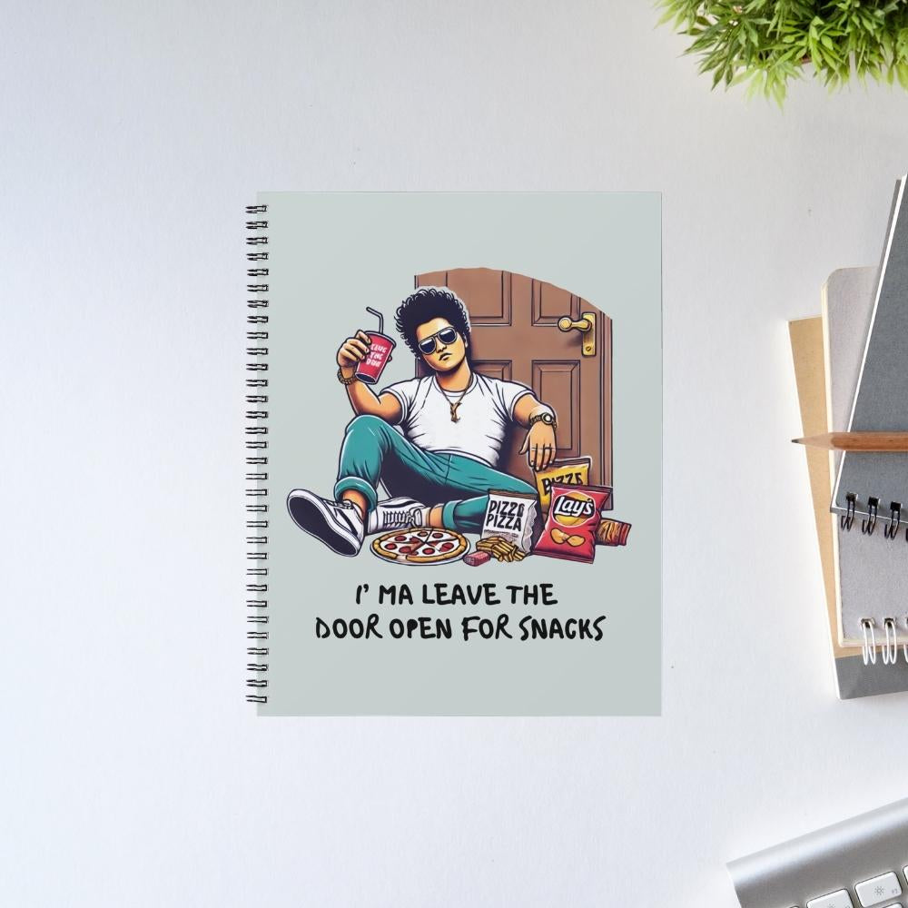Notebook with a design of a person sitting on a door with snacks, on a light gray background. Bruno Mars Gift The Banyan Tee India