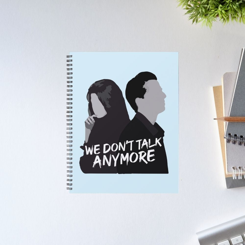 We Don't Talk Anymore Notebook – A5 spiral journal with light blue cover featuring silhouette couple illustration and bold lyric text, Charlie Puth Selena Gomez fan merch, pop music diary, The Banyan Tee