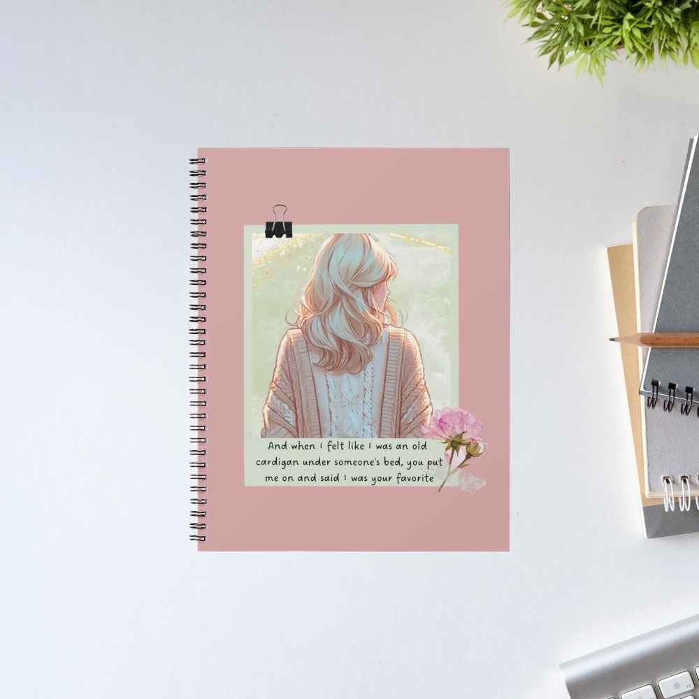 Taylor Swift Old Cardigan spiral notebook with an illustrated woman in a knit cardigan, a pink peony and the 'old cardigan under someone's bed' lyric on a dusty rose cover – unruled notepad diary, The Banyan Tee