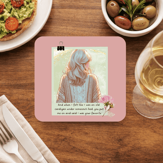 Taylor Swift Old Cardigan coaster with an illustrated woman in a cable-knit cardigan seen from behind, a pink peony and the old cardigan lyric, on dusty rose
